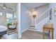 Bright hallway with wood floors, white staircase, and a glimpse into a living area at 2510 W Cleveland St # 3, Tampa, FL 33609