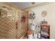 Bathroom with a tiled shower, toilet, and decorative shelves at 2940 Bay View Dr, Safety Harbor, FL 34695