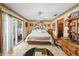 Spacious main bedroom featuring tiled floors, a ceiling fan, and a large window at 2940 Bay View Dr, Safety Harbor, FL 34695