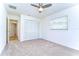 This bedroom includes plush carpeting, a ceiling fan, and closet with louvered doors at 3046 Lake Padgett Dr, Land O Lakes, FL 34639