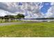 Scenic park with picnic gazebos and a path alongside a serene lake at 3046 Lake Padgett Dr, Land O Lakes, FL 34639