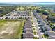 An aerial view of a planned community with neatly arranged homes, green spaces, and tree-lined streets at 3664 Zephyr Preserve Pl, Zephyrhills, FL 33541