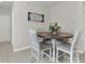 Cozy dining area featuring a round wooden table with four chairs, and decor at 3664 Zephyr Preserve Pl, Zephyrhills, FL 33541