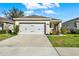 Charming single-story home featuring a two-car garage, landscaped yard, and welcoming front porch on a beautiful day at 3664 Zephyr Preserve Pl, Zephyrhills, FL 33541