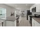 Modern kitchen showcasing stainless steel appliances, granite countertops, a large island with bar seating, and tiled flooring at 3664 Zephyr Preserve Pl, Zephyrhills, FL 33541