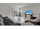 Bright living room featuring tile floors, a ceiling fan, sliding glass doors to the backyard, and comfortable furnishings at 3664 Zephyr Preserve Pl, Zephyrhills, FL 33541