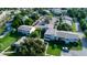 An aerial view of the property showcasing the buildings, parking, and green spaces at 423 Windrush Bay Dr, Tarpon Springs, FL 34689