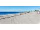 Wide-angle view of the sandy shoreline and clear, blue ocean at 423 Windrush Bay Dr, Tarpon Springs, FL 34689