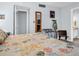 Cozy bedroom featuring a vanity mirror, an ironing board and laundry bins, and bright doorway at 423 Windrush Bay Dr, Tarpon Springs, FL 34689