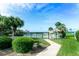 Community pool area with a fenced enclosure and beautiful landscaping at 423 Windrush Bay Dr, Tarpon Springs, FL 34689