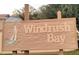 Windrush Bay community sign with sailboat on a wood tone sign at 423 Windrush Bay Dr, Tarpon Springs, FL 34689