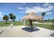 Outdoor seating area with thatched roof, perfect for relaxing by the water at 423 Windrush Bay Dr, Tarpon Springs, FL 34689