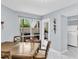 Cozy dining area with wooden table set and lots of natural light through the sliding glass door at 423 Windrush Bay Dr, Tarpon Springs, FL 34689