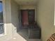 Warm condo entrance with a red door and a storage bench at 423 Windrush Bay Dr, Tarpon Springs, FL 34689