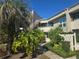 Inviting condo exterior showcasing lush landscaping, a walkway and a charming facade at 423 Windrush Bay Dr, Tarpon Springs, FL 34689