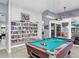 Community game room with a pool table, bookshelf, and comfortable seating at 423 Windrush Bay Dr, Tarpon Springs, FL 34689