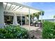 Relaxing outdoor dining area with a grill, seating, and shade at 423 Windrush Bay Dr, Tarpon Springs, FL 34689