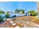 A spacious back yard featuring chairs, a palm tree, and a white fence at 4606 W Oakellar Ave, Tampa, FL 33611