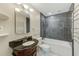 Elegant bathroom with a combination tub and shower, granite countertop and a heated towel rack at 4606 W Oakellar Ave, Tampa, FL 33611