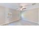 Bright bedroom featuring wood-look flooring, ceiling fan, and natural light from two windows at 4606 W Oakellar Ave, Tampa, FL 33611