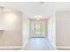 Bright entryway with a decorative front door, light hardwood floors, and neutral walls at 4606 W Oakellar Ave, Tampa, FL 33611