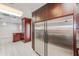 Kitchen featuring stainless steel refrigerator, dark cabinets and tile backsplash at 4606 W Oakellar Ave, Tampa, FL 33611