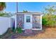 This shows a backyard shed featuring a door and wood plank siding at 4606 W Oakellar Ave, Tampa, FL 33611