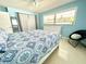 Bright bedroom with a blue color scheme, patterned bedding, and ample natural light at 619 59Th Ave, St Pete Beach, FL 33706