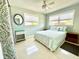 Styled bedroom features modern decor, light walls, ceiling fan, and two windows at 619 59Th Ave, St Pete Beach, FL 33706