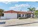 Charming single-story home with a brick driveway, a white facade, and a vibrant red tiled roof at 619 59Th Ave, St Pete Beach, FL 33706