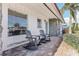 Welcoming front porch featuring rocking chairs and stone accents for relaxing outdoor enjoyment at 619 59Th Ave, St Pete Beach, FL 33706