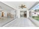 Bright sunroom featuring white tile floors, ceiling fan, and sliding glass doors to outdoor space at 619 59Th Ave, St Pete Beach, FL 33706