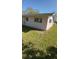 A side exterior view of a home with white walls, windows, and a green lawn at 6223 12Th S St, St Petersburg, FL 33705