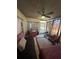 Cozy sunroom featuring wood paneled ceiling, ceiling fan, tile floor, and draped windows at 6223 12Th S St, St Petersburg, FL 33705