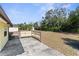 Large backyard with a shed in the background surrounded by mature trees and vegetation at 6353 Spring Hill Dr, Spring Hill, FL 34606