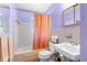 Bathroom with purple walls featuring a shower/tub combo, toilet, and pedestal sink at 6353 Spring Hill Dr, Spring Hill, FL 34606