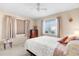 Bright bedroom featuring neutral walls, ceiling fan, and large window overlooking the outdoors at 6353 Spring Hill Dr, Spring Hill, FL 34606