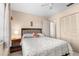 Bedroom with a ceiling fan, neutral walls, window, and view into the hallway at 6353 Spring Hill Dr, Spring Hill, FL 34606