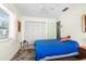 Bedroom with blue bedding, a ceiling fan, and closet at 6353 Spring Hill Dr, Spring Hill, FL 34606