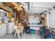 View of garage featuring work bench, shelves, fan, lighting, and equipment at 6353 Spring Hill Dr, Spring Hill, FL 34606