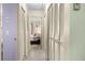 Hallway featuring neutral walls, closet with louvered doors, and a view into the bedroom at 6353 Spring Hill Dr, Spring Hill, FL 34606