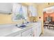 Well lit kitchen featuring updated countertops and a clear view of the dining area at 6353 Spring Hill Dr, Spring Hill, FL 34606