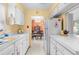 Bright kitchen with white cabinets and countertops with an view to the dining room at 6353 Spring Hill Dr, Spring Hill, FL 34606