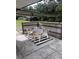 Covered patio with outdoor table and chairs on a patterned rug at 6353 Spring Hill Dr, Spring Hill, FL 34606