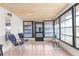 Enclosed sunroom featuring tile flooring, wood ceiling, and many windows at 6353 Spring Hill Dr, Spring Hill, FL 34606