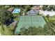 Aerial view of community tennis courts next to a community pool, playground, and surrounding homes at 692 Greenglen Ln, Palm Harbor, FL 34684