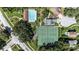 Community aerial view showcasing tennis courts, pool, playground, and residences in a neighborhood setting at 692 Greenglen Ln, Palm Harbor, FL 34684