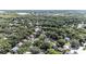 Sprawling aerial view of a leafy suburban neighborhood close to a glistening lake at 692 Greenglen Ln, Palm Harbor, FL 34684