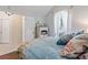 Bright bedroom featuring a coastal theme, vaulted ceiling, and natural light from the window at 692 Greenglen Ln, Palm Harbor, FL 34684