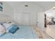 Cozy bedroom with beach themed bedding, a spacious closet, and neutral paint at 692 Greenglen Ln, Palm Harbor, FL 34684